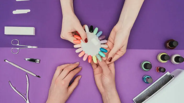 A group of hands with nail tools on a purple background.