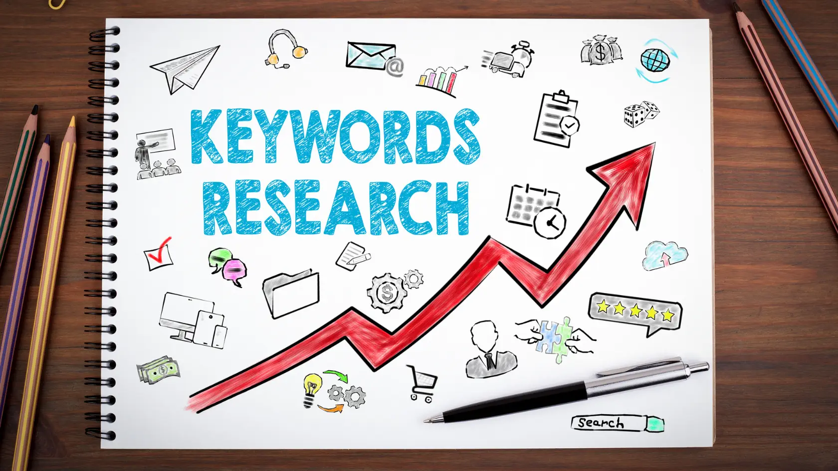 A notebook with the words keywords research on it.
